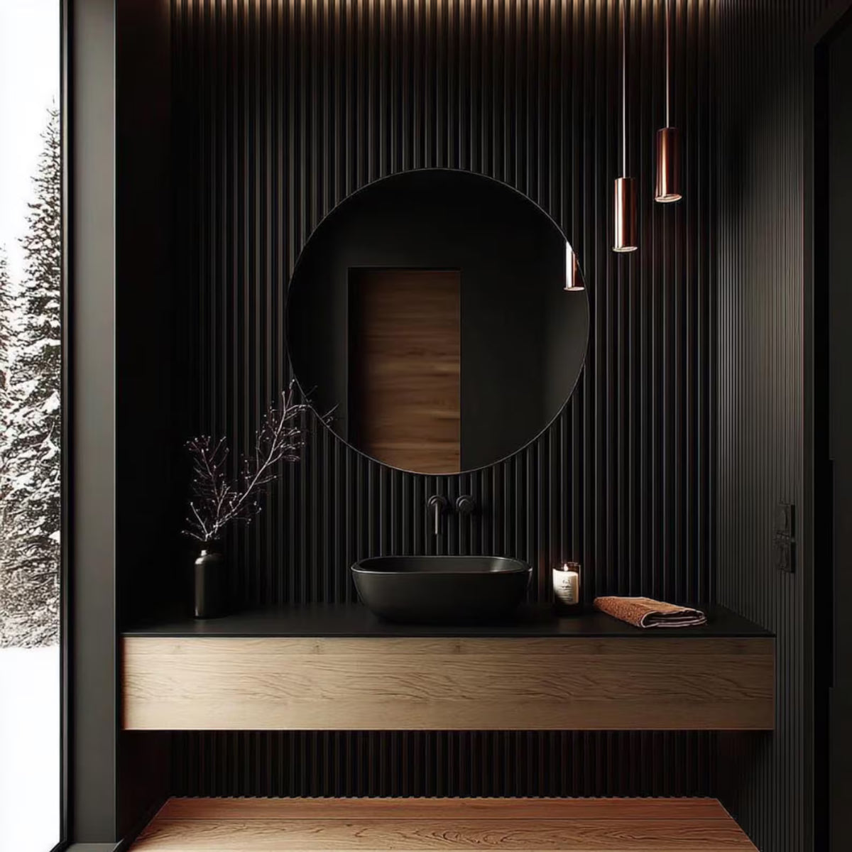 Modern bathroom vanity with a round black vessel sink, matte black countertop, wood floating cabinet, a large round black mirror, and a dark ribbed wall. A window on the left shows a snowy outdoor scene, and two copper pendant lights hang above.